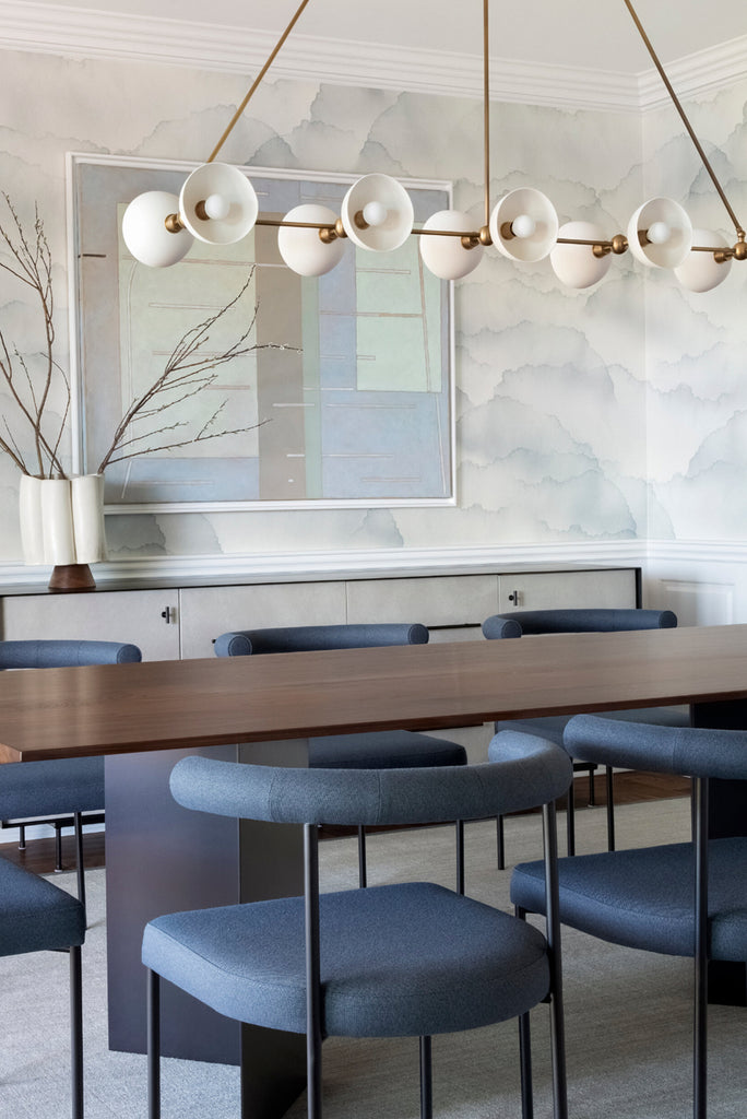 Wallpaper installation in dining room by ChangoandCo watercolour cloud wallpaper